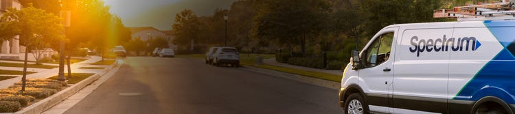 Spectrum truck driving through a community