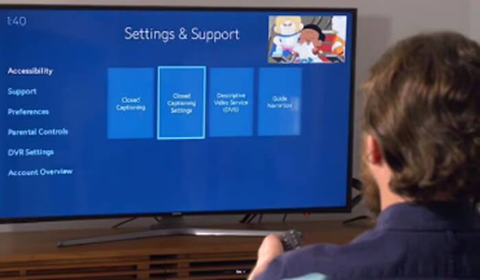 a man using Spectrum's accessibility features on a TV