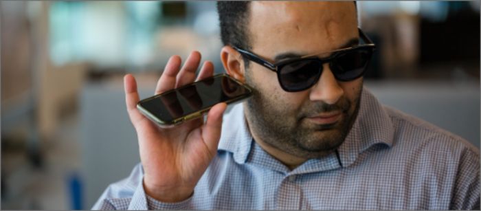Blind man using Spectrum Mobile accessibility tools.