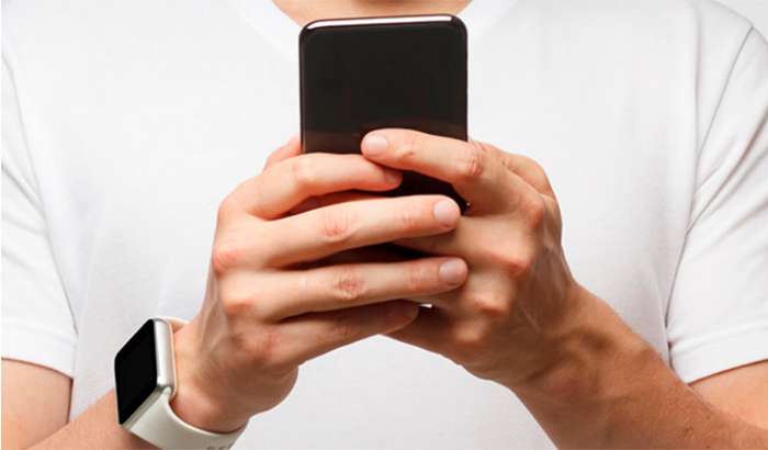 Person holding their mobile phone