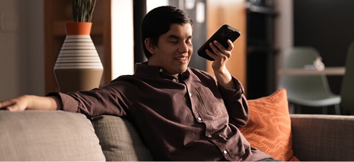 a young man using the Spectrum Access App at home