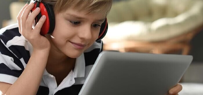 A boy streaming content on his tablet with Spectrum