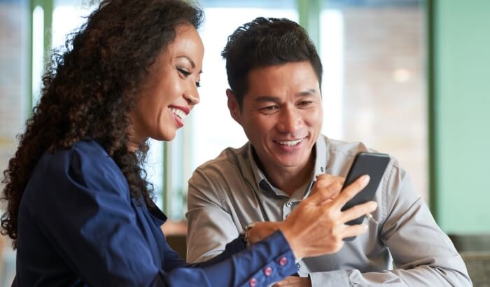Couple interacting with mobile phone