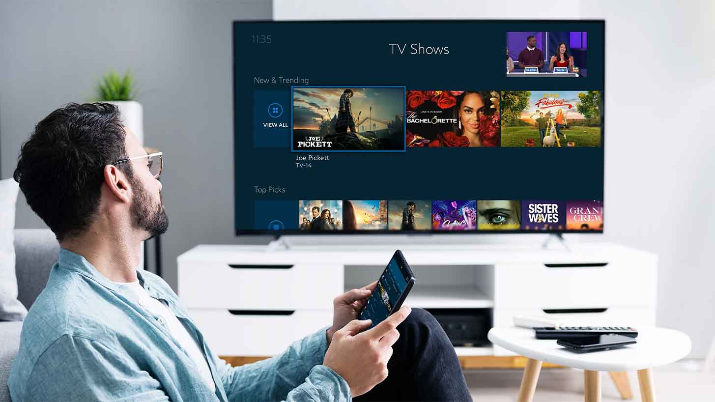 Man Vewing TV Show Options on a TV.
