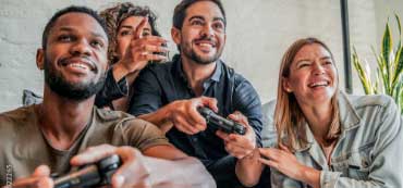 Group of friends gaming and laughing. 