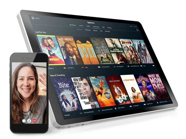 Phone with video calling and tablet featuring On Demand content from Spectrum TV. 