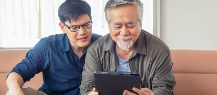 Two men using a tablet with automated cyberattack defense