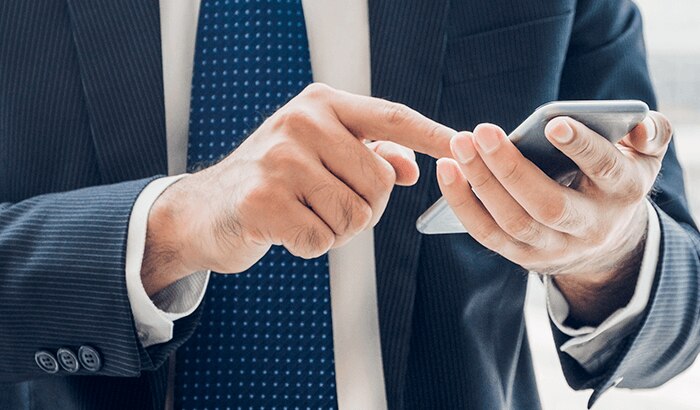 Business owner on phone staying connected with Spectrum Mobile on-the-go.