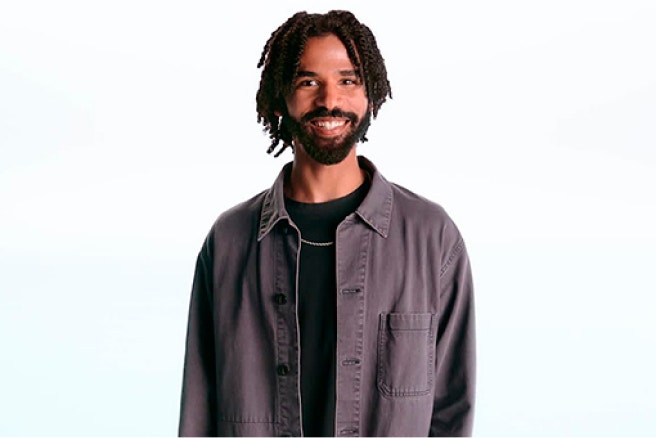 Smiling man standing against a white background.