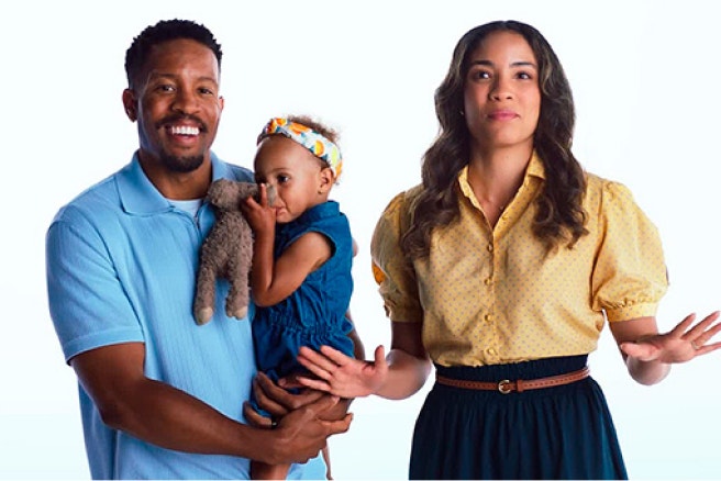 Family standing together against a white background