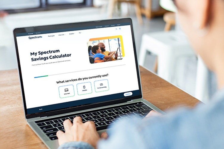 Customer using the My Spectrum Savings Calculator on a laptop.