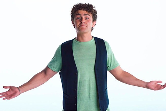 Man gesturing with both arms against a white background.