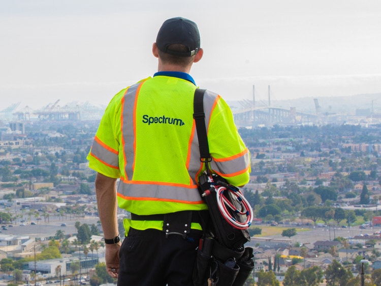 Spectrum technician overlooking a California city.