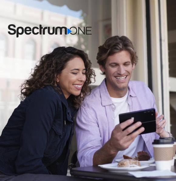 Group of people smiling looking at tablet