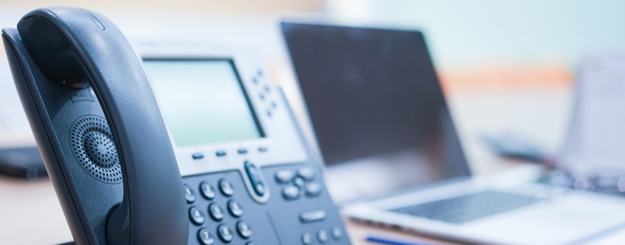 915623194 close up soft focus on telephone devices at office desk for customer service support concept