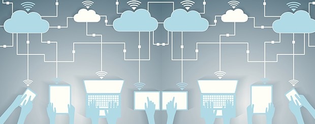 Top-down view of hands using various connected devices, such as smartphones, tablets and laptops, which each have WiFi symbols floating above them and pointing up to cloud symbols above them. 