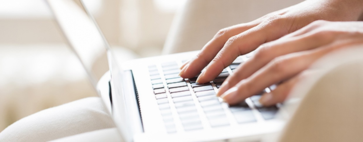 Hands on a laptop keyboard