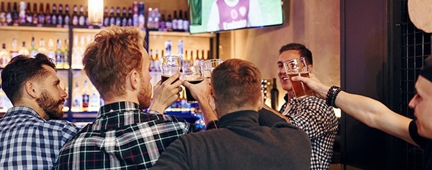 Group of people together indoors in the pub have fun at weekend time