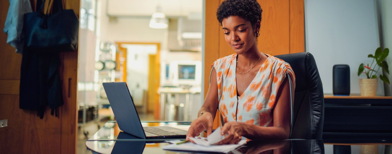 A businesswoman uses a laptop in her office