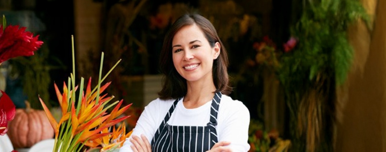Smiling woman wearing an apron at work. 