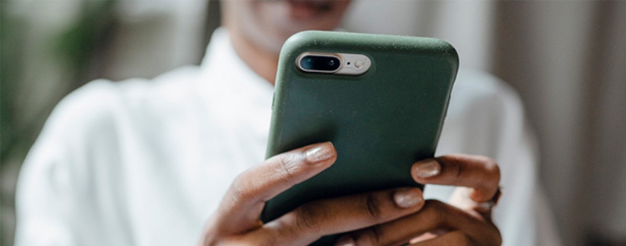 Business woman texts on smart phone.