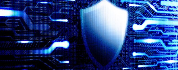 Shield symbol representing cybersecurity laid over a futuristic background meant to represent the Internet.