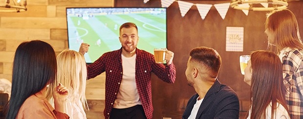 Bar patrons celebrating sports on TV