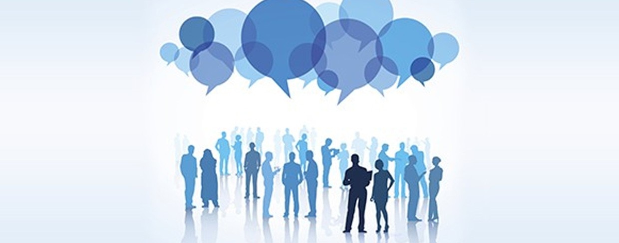 Silhouettes of business people mingling with speech bubbles above their heads