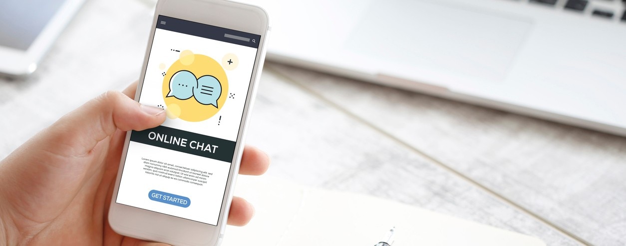 914019262 Person holding a smartphone displaying an online chat screen with a “Get Started” button