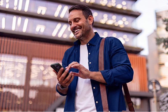 man outdoors using mobile device