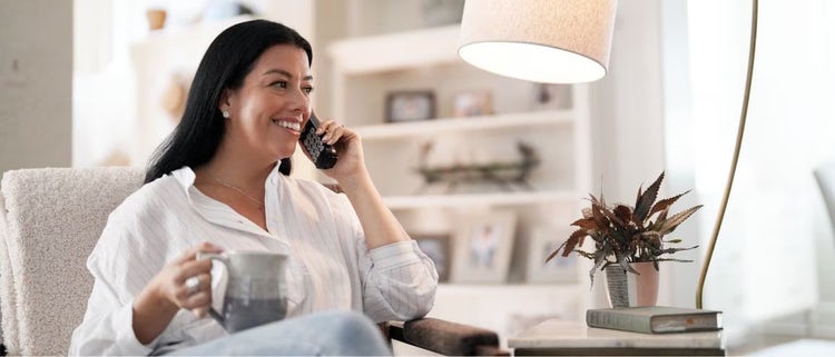 Mujer usando teléfono residencial