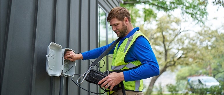 A Spectrum service technician working at a home. 