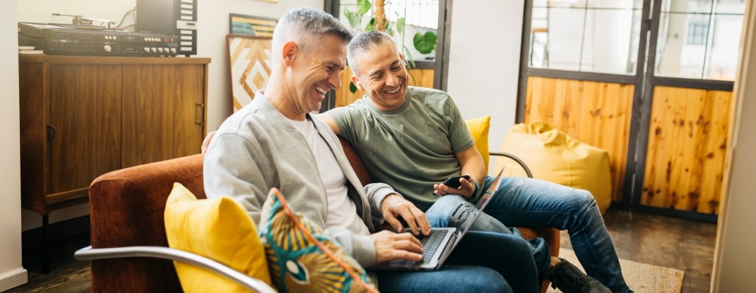 A father and son looking at laptop