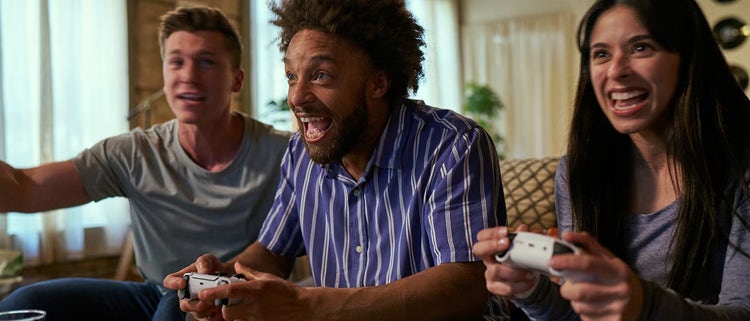 Two Men and One Women Gaming on Couch