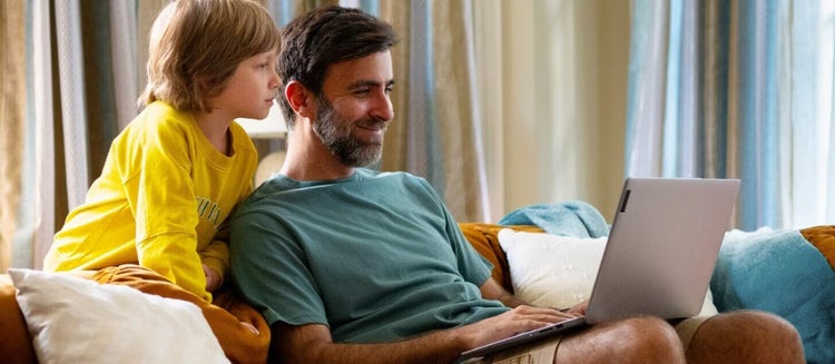 A father and son looking at laptop