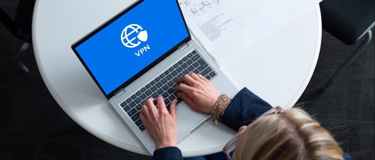 Women typing on a laptop and accessing a VPN.