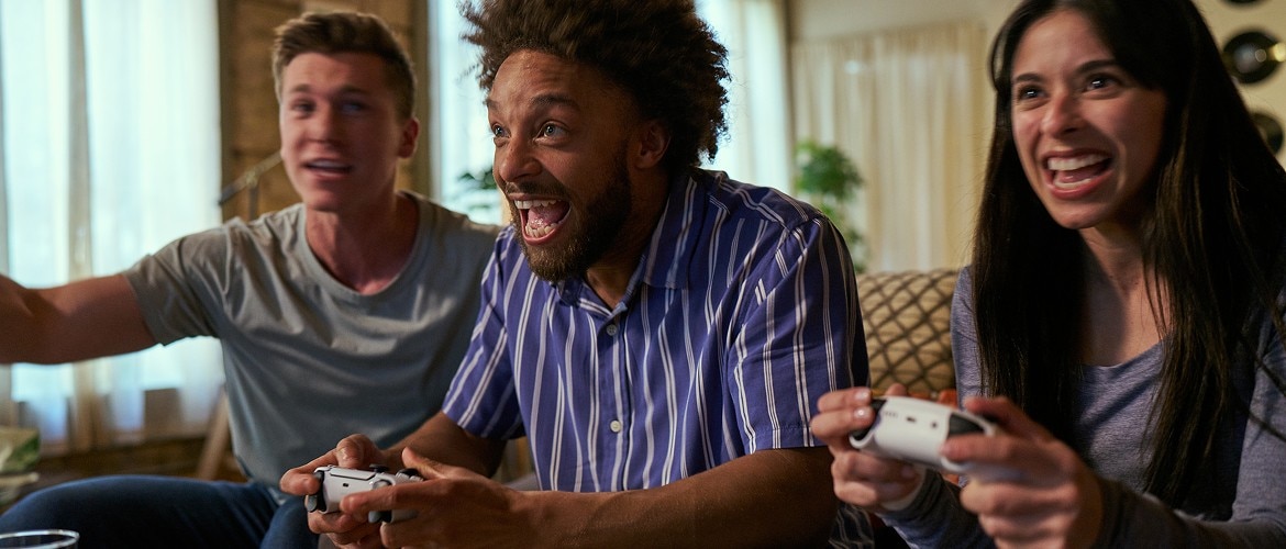 Two Men and One Women Gaming on Couch
