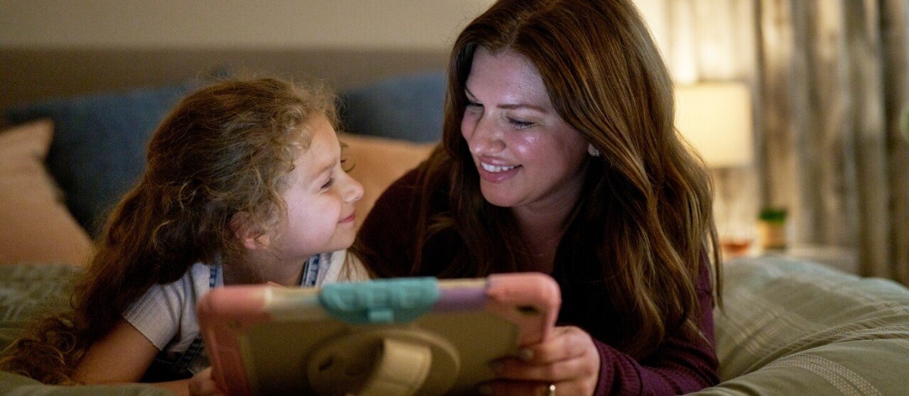 Mother and daughter comparing Mobile plans on a phone