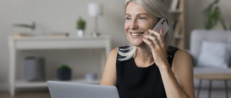 Cliente feliz de Spectrum Mobile usando su teléfono móvil y laptop.