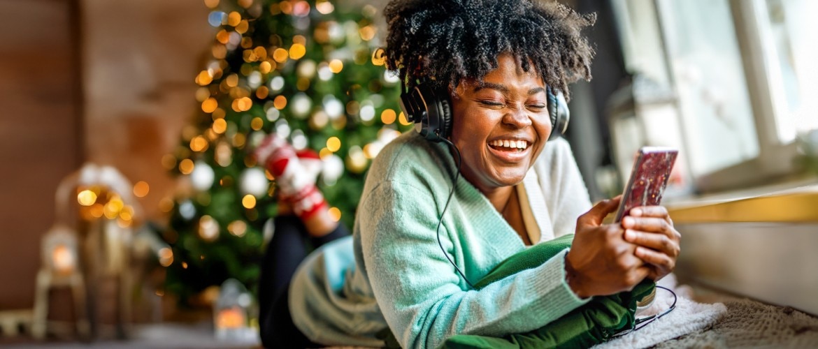 Man looking at his phone, smiling. 