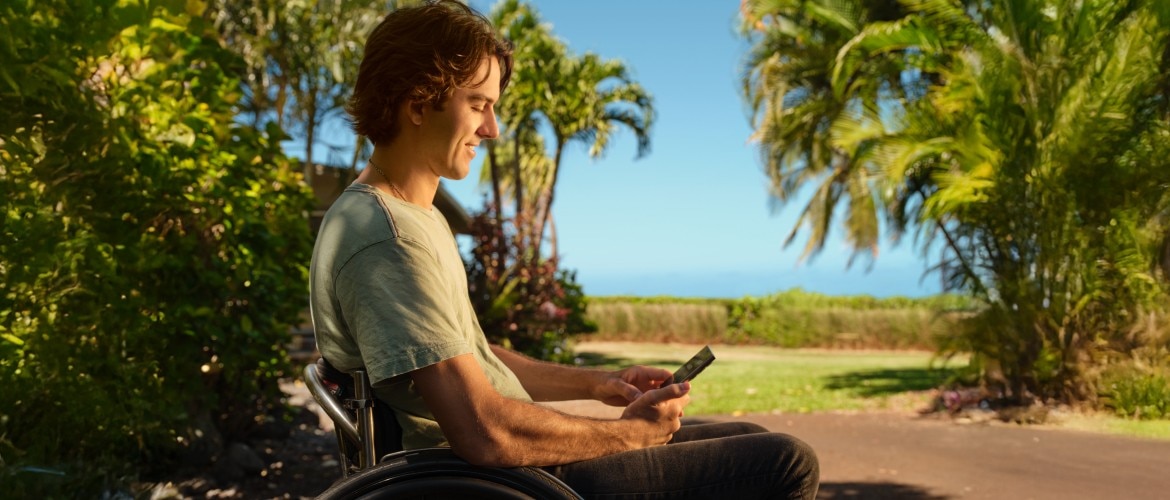 Man looking at his phone, smiling. 