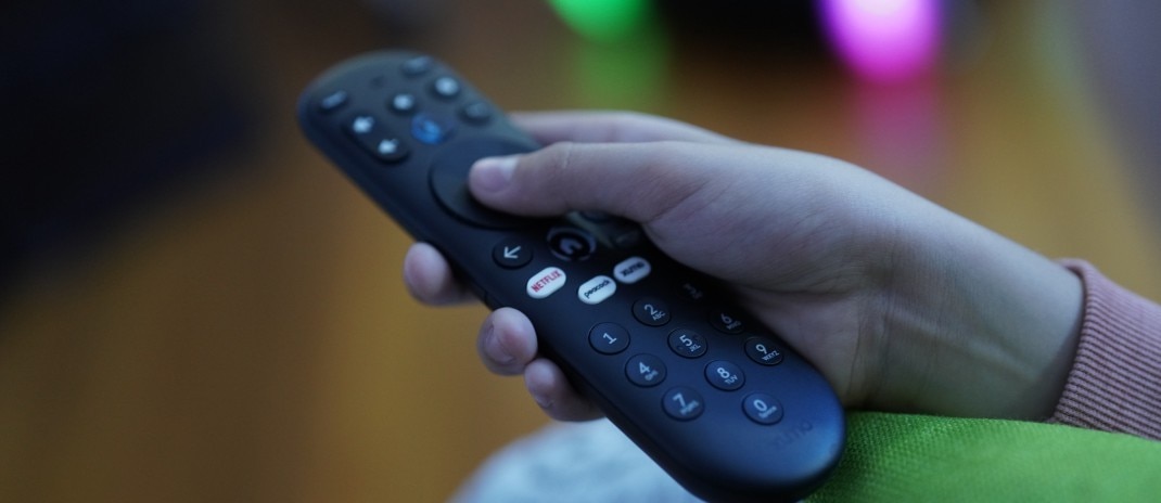 A woman using a tablet while smiling. 