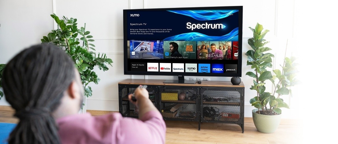 Person watching TV with a Xumo Stream Box